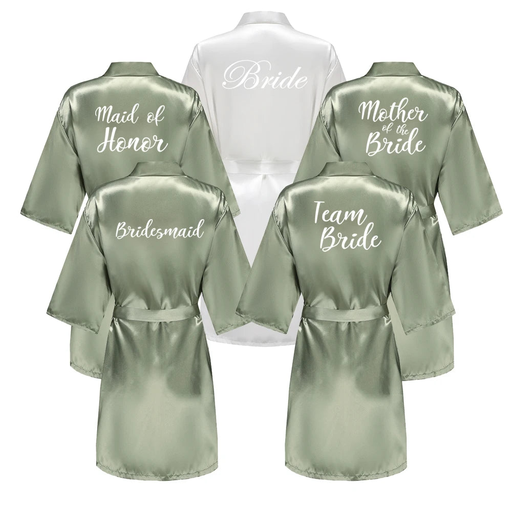 Sage green bridal robes with “Bridesmaid” title on back