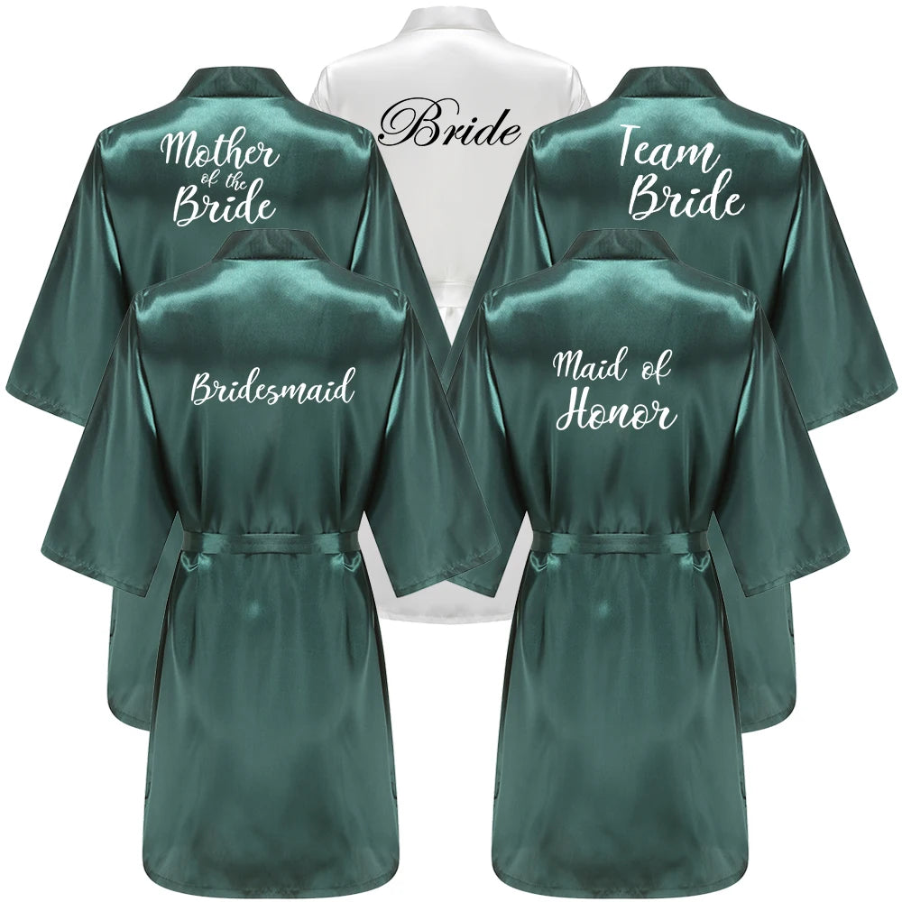 Emerald green bridal robes with “Bride” "Bridesmaid" "team bride" and "Mother of the bride" title on back