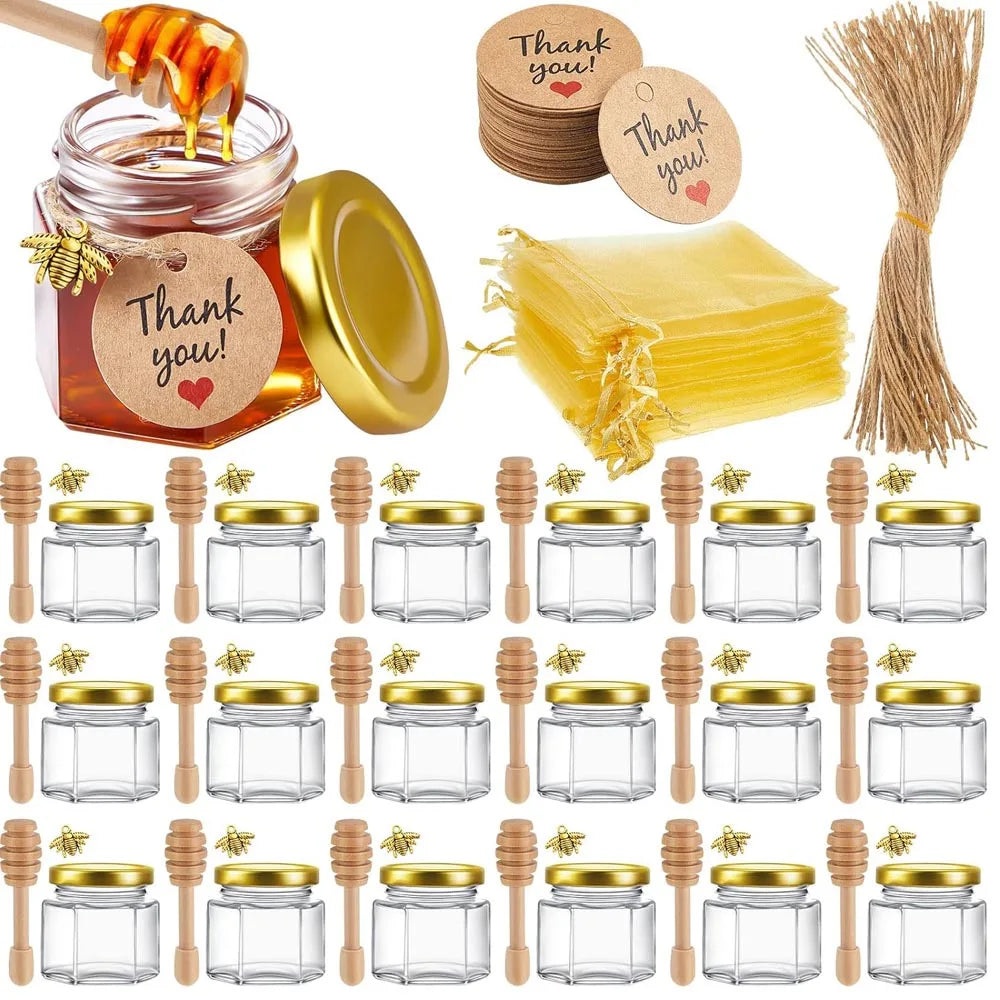 Mini honey jars with wooden dippers and gold gift bags – wedding favours