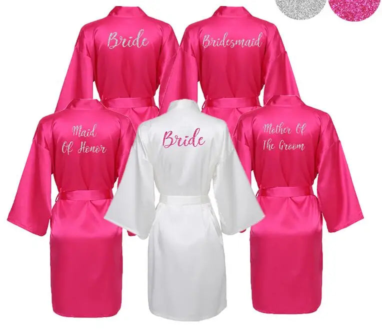 Hot pink bridal party robes with “Bride” "Bridesmaid", Maid of Honour" and "mother of the groom" titles on back