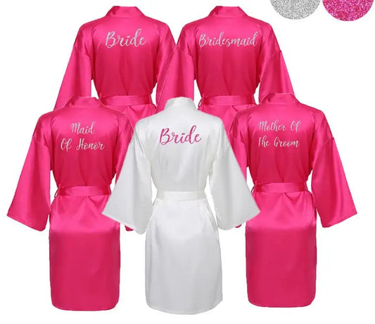 Hot pink bridal party robes with “Bride” "Bridesmaid", Maid of Honour" and "mother of the groom" titles on back