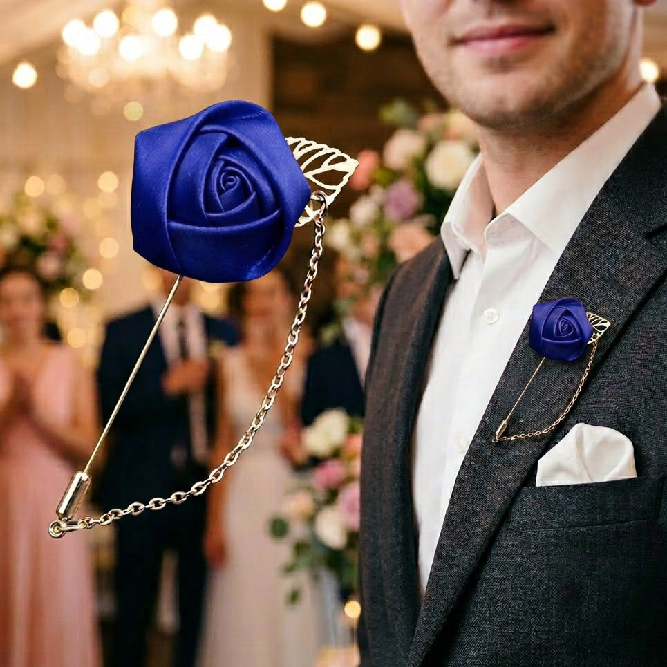 Man wearing a dark suit with a blue rose lapel pin at an event.