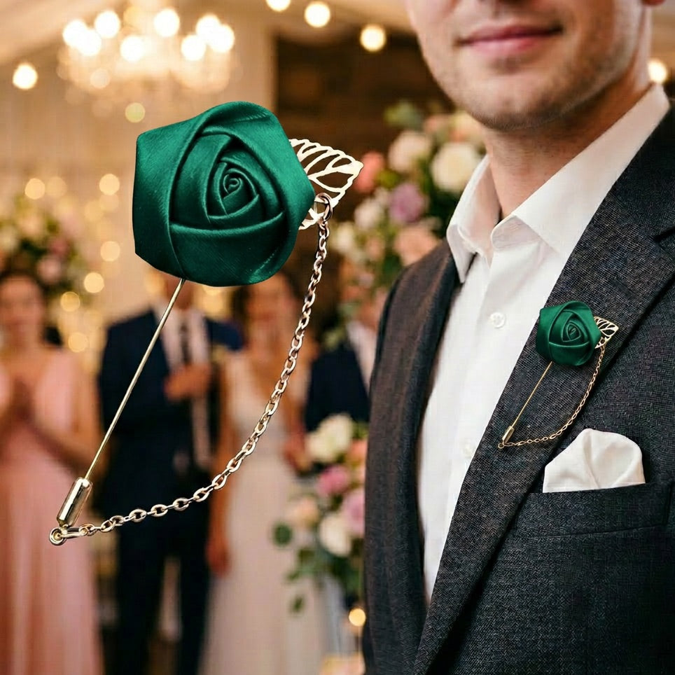 Man wearing a green rose lapel pin with a chain in a festive setting