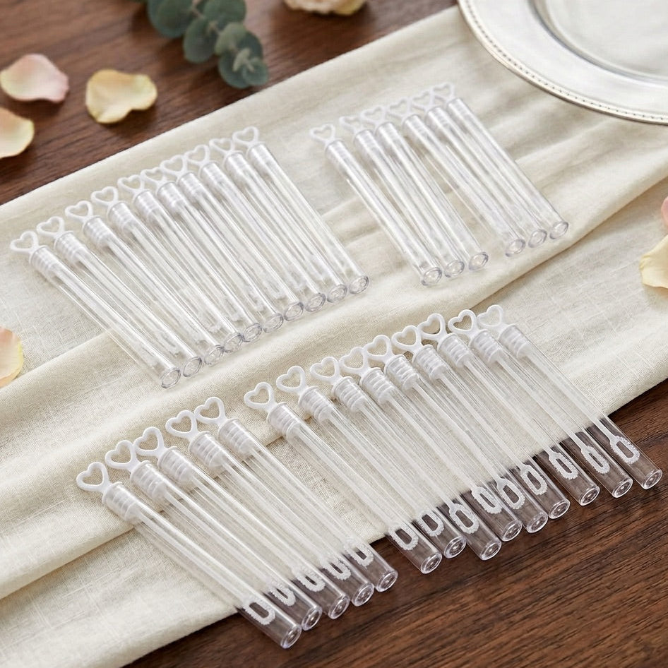Set of clear plastic bubble tubes with heart designs on a wooden surface.