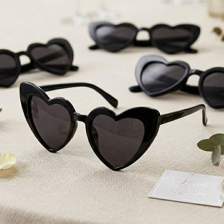 Heart-shaped sunglasses on a table with decorative elements