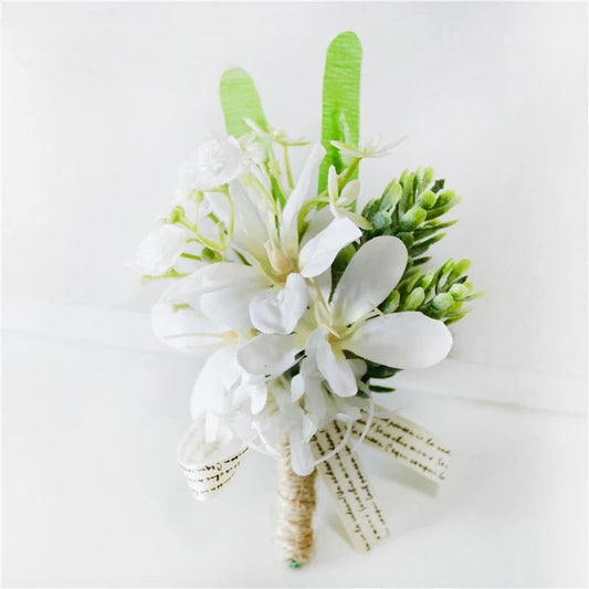 White artificial floral wedding buttonhole with ribbon finish