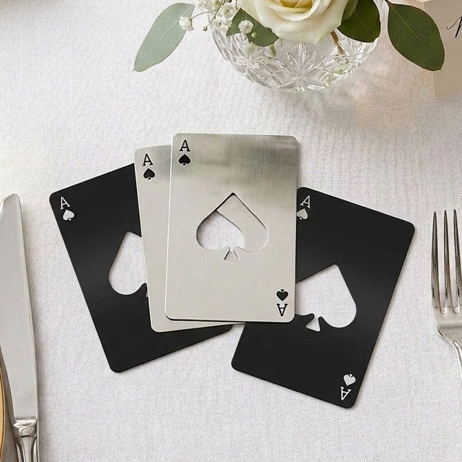 Playing card favours table number on a wedding reception table with flowers and place settings.