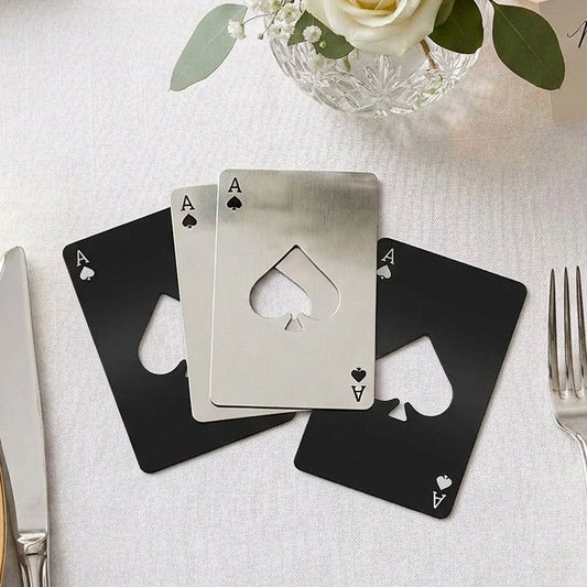 Playing card favours table number on a wedding reception table with flowers and place settings.