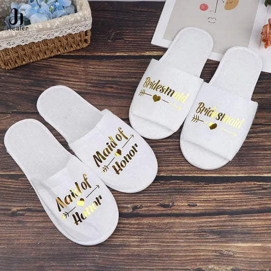 White wedding slippers with gold printed titles for the bridal party