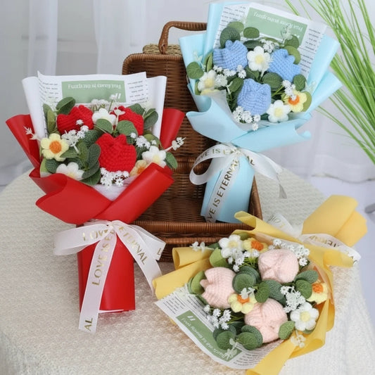 Three colorful flower bouquets with ribbons on a table.