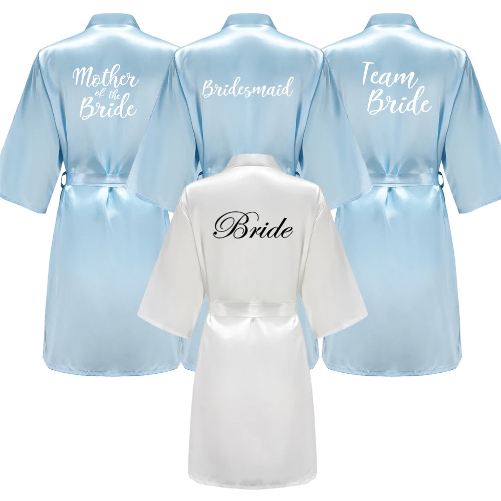 Light blue bridal party robes with “Bridesmaid” title in white writing