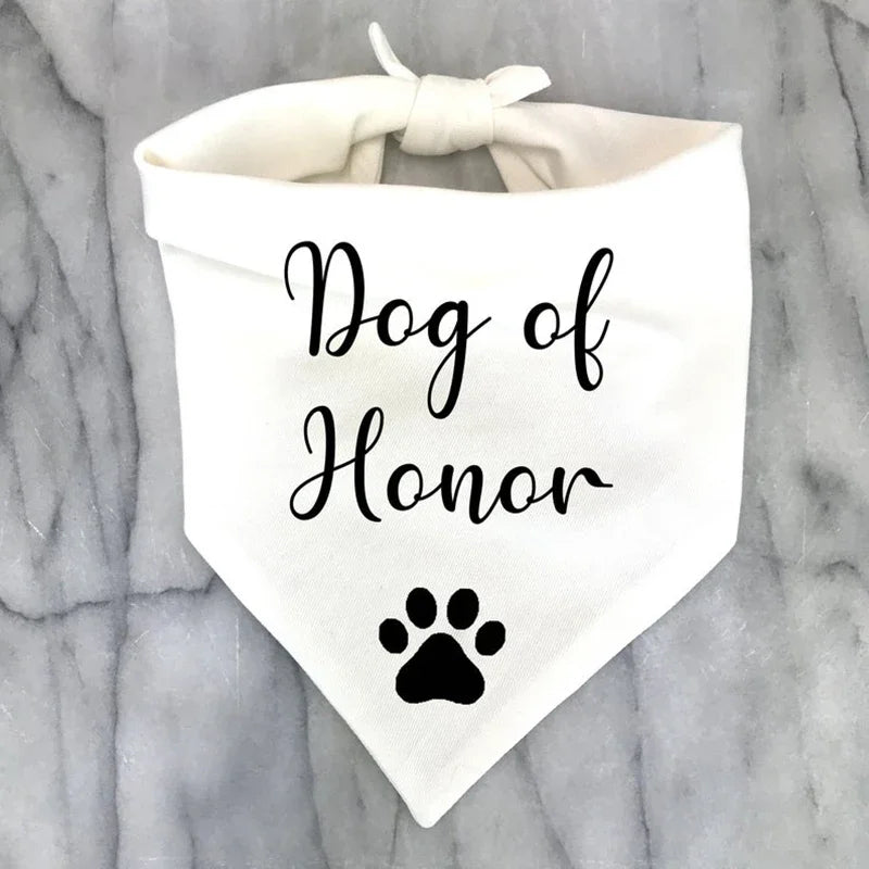 White bandana for dog, says "Dog of honour" on it.