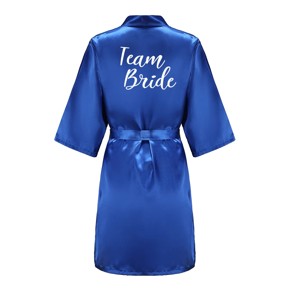 Blue satin robe with 'Team Bride' text on a white background