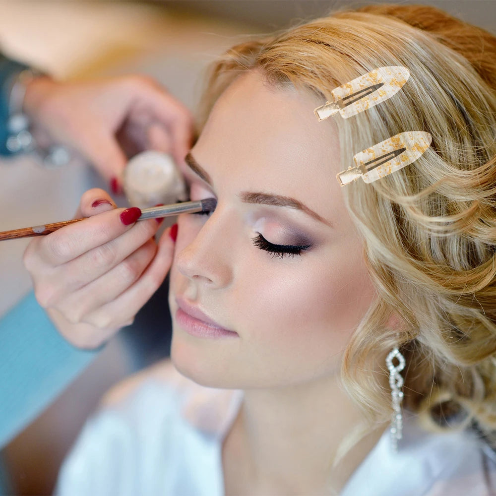 Woman having make-up done whilst wearing Gold Bridal Party Hair Setting Clips.