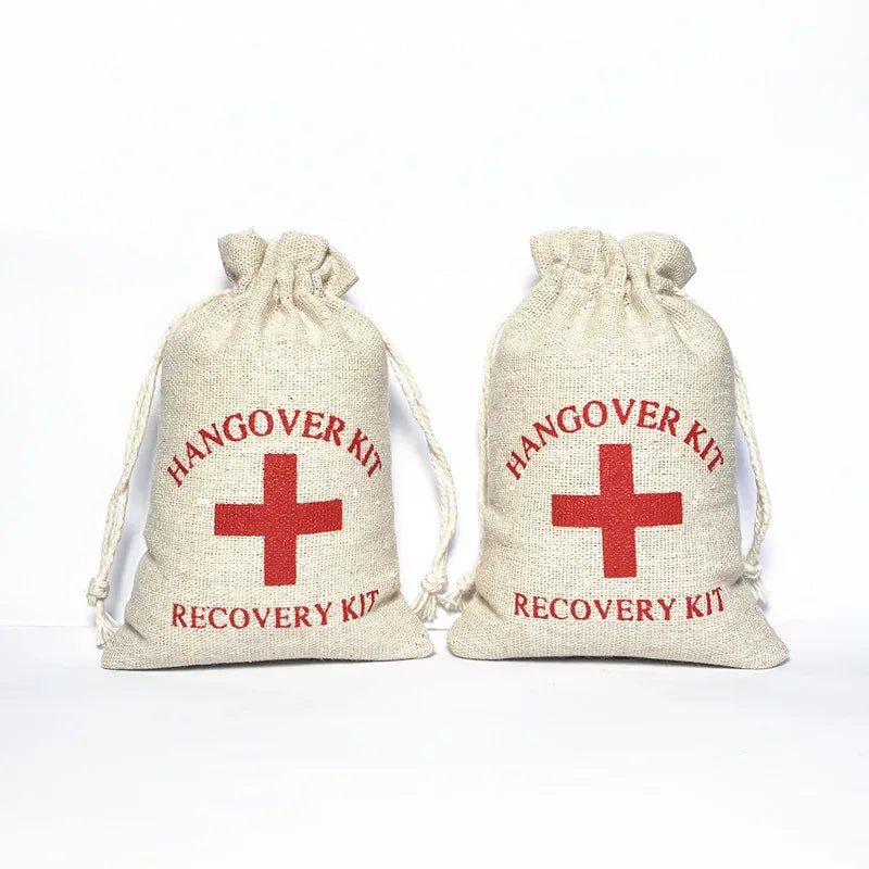 White cotton wedding favour bag with red ‘Hangover Recovery Kit’ text and red cross design
