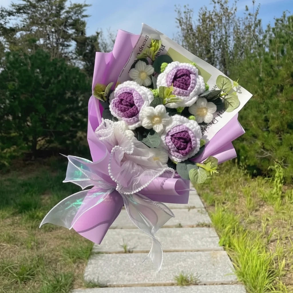 Bouquet of purple and white flowers wrapped in purple paper.