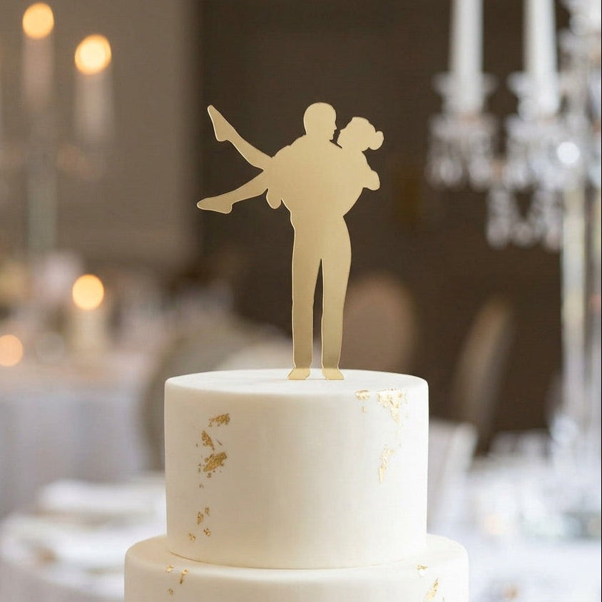 Two-tiered wedding cake with a decorative topper in a formal setting